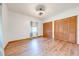 Bright bedroom featuring hardwood floors, closet and a modern ceiling fan with light at 3975 Rambler Ave, St Cloud, FL 34772