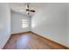 Bedroom featuring wood-look floors, a ceiling fan, and a window letting in natural light at 3975 Rambler Ave, St Cloud, FL 34772
