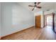 Bedroom featuring wood-look floors, a ceiling fan, and a closet in the background at 3975 Rambler Ave, St Cloud, FL 34772