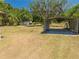 A metal carport sits on a lot with grass and trees in the background at 3975 Rambler Ave, St Cloud, FL 34772