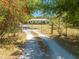 Gated drive with view to single-story home at 3975 Rambler Ave, St Cloud, FL 34772