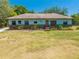 Charming single-story home featuring a well-maintained lawn and brick-accented garden beds under a clear blue sky at 3975 Rambler Ave, St Cloud, FL 34772