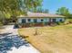 Inviting single-story home featuring a covered carport and a well-maintained lawn leading to the front door at 3975 Rambler Ave, St Cloud, FL 34772
