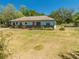 Wide shot of single-story home with lawn and carport at 3975 Rambler Ave, St Cloud, FL 34772