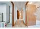 Hallway to rooms featuring tile floors and wood doors at 3975 Rambler Ave, St Cloud, FL 34772