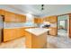 Bright kitchen with a kitchen island, stainless steel appliances and light wood cabinetry at 3975 Rambler Ave, St Cloud, FL 34772