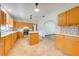 Open kitchen with light wood cabinets, tile floors, a center island and stainless steel appliances at 3975 Rambler Ave, St Cloud, FL 34772