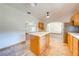 Spacious kitchen with a kitchen island, light wood cabinets, and open access to adjacent rooms at 3975 Rambler Ave, St Cloud, FL 34772