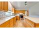 Bright kitchen featuring light wood cabinets, a stone backsplash, and stainless steel appliances at 3975 Rambler Ave, St Cloud, FL 34772