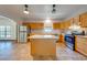 Updated kitchen with stainless steel appliances, granite countertops, and island at 3975 Rambler Ave, St Cloud, FL 34772