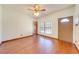 Bright, open living room featuring wood-look floors, a ceiling fan, and a window with natural light at 3975 Rambler Ave, St Cloud, FL 34772