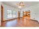 Inviting living room with wood floors, ceiling fan, arched doorway to the kitchen at 3975 Rambler Ave, St Cloud, FL 34772