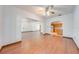 Open living room with hardwood floors leading to kitchen with stainless steel appliances at 3975 Rambler Ave, St Cloud, FL 34772