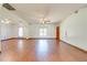 Bright living room with hardwood floors, ceiling fan, and abundant natural light at 3975 Rambler Ave, St Cloud, FL 34772