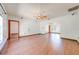Spacious living room featuring hardwood floors, ceiling fan, and arched doorway to additional living space at 3975 Rambler Ave, St Cloud, FL 34772