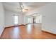 Open-concept living room with ceiling fan and hardwood floors at 3975 Rambler Ave, St Cloud, FL 34772