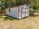 A shed with double doors and ramp sits on a grassy lot at 3975 Rambler Ave, St Cloud, FL 34772