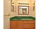 Bathroom vanity with a green counter and wood drawers at 400 E Colonial Dr # 1003, Orlando, FL 32803