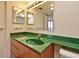 Bathroom featuring a vibrant green countertop and ample vanity lighting at 400 E Colonial Dr # 1003, Orlando, FL 32803