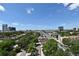 Stunning city view with lush green trees and blue sky for a serene neighborhood scenery at 400 E Colonial Dr # 1003, Orlando, FL 32803