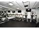 Gym area featuring treadmills, elliptical machines, black rubber flooring and mirrored wall at 400 E Colonial Dr # 1003, Orlando, FL 32803