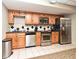 Kitchen with wood cabinets, stainless steel appliances, and black granite countertops at 400 E Colonial Dr # 1003, Orlando, FL 32803