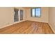 A bright living room featuring modern wood-look flooring and balcony access at 400 E Colonial Dr # 1003, Orlando, FL 32803
