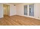 The living room has wood-look floors and doors to the balcony at 400 E Colonial Dr # 1003, Orlando, FL 32803