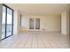Bright living room featuring tile flooring, balcony access, and sliding glass doors at 400 E Colonial Dr # 1003, Orlando, FL 32803