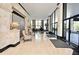 Inviting lobby with tile flooring, stylish chairs, piano, and floor-to-ceiling windows for ample natural light at 400 E Colonial Dr # 1003, Orlando, FL 32803