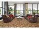 Elegant lobby area with comfortable seating, stylish rug, and large windows overlooking the lush landscape at 400 E Colonial Dr # 1003, Orlando, FL 32803