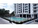 Exterior view of the building with the community pool and lounge area in the foreground at 400 E Colonial Dr # 1003, Orlando, FL 32803