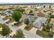 This bird's eye aerial view shows a green home with solar panels in a Gathering-friendly neighborhood with tree-lined streets at 429 Rona Ln, Davenport, FL 33897