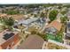An aerial view features a large, fenced backyard in a quiet community with mature landscaping and nearby amenities at 429 Rona Ln, Davenport, FL 33897