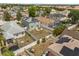 A bird's eye view shows a large backyard, solar panels, a white fence, and a patio great for outdoor relaxing at 429 Rona Ln, Davenport, FL 33897