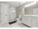 Elegant bathroom with marble shower, white tile floors, and double sink vanity at 429 Rona Ln, Davenport, FL 33897