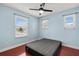 Bedroom with blue walls, wood floor, and a comfortable bed at 429 Rona Ln, Davenport, FL 33897