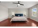 Bright bedroom showcases a ceiling fan, hardwood floors and natural light at 429 Rona Ln, Davenport, FL 33897