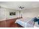 Primary bedroom with mounted TV, ceiling fan, and access to ensuite bathroom at 429 Rona Ln, Davenport, FL 33897