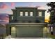 A stunning front exterior showcases a two-story home with attached two-car garage, lush landscaping, and eye-catching curb appeal at 429 Rona Ln, Davenport, FL 33897