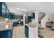 Modern kitchen features blue cabinets, a granite countertop, and stainless steel appliances at 429 Rona Ln, Davenport, FL 33897