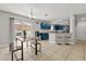 Open-concept dining and kitchen area with bar stools and view of the outdoor patio at 429 Rona Ln, Davenport, FL 33897