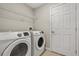 Laundry room featuring new front load washer and dryer with white door at 429 Rona Ln, Davenport, FL 33897
