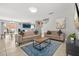 Spacious living room connected to kitchen with sofas and a rustic wood coffee table on a blue rug at 429 Rona Ln, Davenport, FL 33897