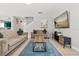 Bright living room showcases two sofas, a wooden coffee table, and a blue area rug at 429 Rona Ln, Davenport, FL 33897