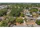 Aerial shot showcasing the home's location within a lush, green neighborhood with nearby community features at 5326 Weirwood Ave, Orlando, FL 32810