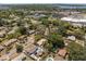 Wide aerial view showing the house's location with neighborhood amenities, cityscape, and waterfront views at 5326 Weirwood Ave, Orlando, FL 32810