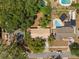 Birds eye view showing the house layout, mature trees, neighboring houses, and the surrounding community at 5326 Weirwood Ave, Orlando, FL 32810