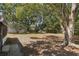 Spacious backyard with mature trees providing ample shade and privacy in a serene outdoor setting at 5326 Weirwood Ave, Orlando, FL 32810