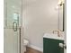 Bathroom with glass shower, green vanity, and gold hardware details at 5326 Weirwood Ave, Orlando, FL 32810